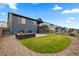 Landscaped backyard with lawn, stone border, outdoor furniture, and deck at 8132 Mt Harvard Rd, Littleton, CO 80125