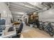 Finished basement with desk, workspace, storage shelves, and a bicycle at 8132 Mt Harvard Rd, Littleton, CO 80125