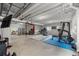 The spacious basement has exposed ceilings and is perfect for a home gym with workout equipment at 8132 Mt Harvard Rd, Littleton, CO 80125