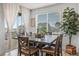 Dining room features an elegant table with seating, a large window, and natural light at 8132 Mt Harvard Rd, Littleton, CO 80125
