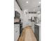 Bright kitchen with stainless steel appliances, white cabinets, hardwood floors, and tiled backsplash at 8132 Mt Harvard Rd, Littleton, CO 80125
