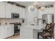 Bright kitchen with a white island, stainless steel appliances, and stylish pendant lighting at 8132 Mt Harvard Rd, Littleton, CO 80125