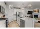 Modern kitchen with stainless steel appliances, white cabinets, hardwood floors, and a large island at 8132 Mt Harvard Rd, Littleton, CO 80125