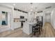 Modern kitchen features white cabinets, island with seating, and stainless steel appliances at 8132 Mt Harvard Rd, Littleton, CO 80125