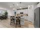 Contemporary kitchen with white cabinets, hardwood floors, a large island, and seamless transition to dining area at 8132 Mt Harvard Rd, Littleton, CO 80125