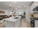 Modern white kitchen featuring stainless steel appliances, hardwood floors, and seamless transition to living area at 8132 Mt Harvard Rd, Littleton, CO 80125