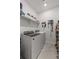 This tidy laundry room features modern washer and dryer units, shelving, and organized storage solutions at 8132 Mt Harvard Rd, Littleton, CO 80125