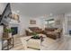 Spacious living room featuring a fireplace, large windows, hardwood floors, and a comfortable brown sectional at 8132 Mt Harvard Rd, Littleton, CO 80125
