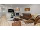 Comfortable living room featuring a brown sectional, fireplace, hardwood floors, and natural light at 8132 Mt Harvard Rd, Littleton, CO 80125