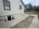 The side of a house with an unfinished basement window and a driveway at 2771 W 1St Ave, Denver, CO 80219