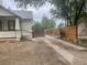 Home's exterior view highlighting the driveway and its access to the fenced backyard at 2771 W 1St Ave, Denver, CO 80219