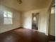 A cozy living room showcasing hardwood floors, natural light, and a view into another room at 2771 W 1St Ave, Denver, CO 80219