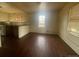 An open-concept room with hardwood floors and natural light filtering through the windows at 2771 W 1St Ave, Denver, CO 80219
