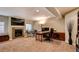 Finished basement with fireplace and large screen TV with seating area and desk at 237 Dayton St, Denver, CO 80230