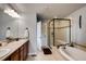 Bright bathroom with a double vanity, a soaking tub, and a separate glass-enclosed shower at 237 Dayton St, Denver, CO 80230