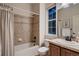 Bathroom with tub and shower and a dark wood vanity at 237 Dayton St, Denver, CO 80230