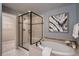 Bright bathroom showcases a soaking tub, frameless shower and open walk-in closet at 237 Dayton St, Denver, CO 80230