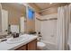 Full bathroom with a tub and shower combination and tile surround at 237 Dayton St, Denver, CO 80230