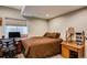 Finished bedroom with desk, chair and natural light from a basement window at 237 Dayton St, Denver, CO 80230