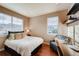 Sunlit bedroom with a comfortable bed, a cozy chair, and an organized workspace at 237 Dayton St, Denver, CO 80230