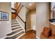 Entryway featuring carpeted stairs with wood handrail, and a light-filled entrance at 237 Dayton St, Denver, CO 80230