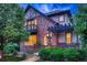 Charming two-story brick home with a cozy front porch and well-maintained landscaping at 237 Dayton St, Denver, CO 80230