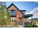 Charming two-story brick home featuring a cozy front porch, a balcony, and a well-manicured yard at 237 Dayton St, Denver, CO 80230