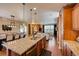 Open-concept kitchen featuring a spacious island that connects to a dining area and a cozy living room at 237 Dayton St, Denver, CO 80230