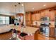Open kitchen with granite countertops, stainless steel appliances, an island and a view into the living room at 237 Dayton St, Denver, CO 80230