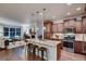 Modern kitchen with a granite island, stainless steel appliances, and stylish pendant lighting at 237 Dayton St, Denver, CO 80230