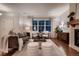 Cozy living room with a fireplace, hardwood floors, and comfortable seating at 237 Dayton St, Denver, CO 80230