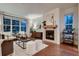 Bright living room with a fireplace, hardwood floors, and large windows at 237 Dayton St, Denver, CO 80230