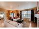 Comfortable living room with a fireplace, large windows and stylish furniture and decor at 237 Dayton St, Denver, CO 80230