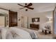 Main bedroom with dark wood sliding door, ceiling fan, and comfortable seating at 237 Dayton St, Denver, CO 80230