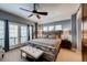 Spacious main bedroom with large windows, a ceiling fan, and a comfortable seating area at 237 Dayton St, Denver, CO 80230