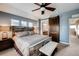 Stylish bedroom featuring a bed with a wooden frame, a fan, and a sliding barn door to the bathroom at 237 Dayton St, Denver, CO 80230