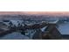 Winter neighborhood view featuring snow-covered rooftops and distant city skyline against the mountains at 237 Dayton St, Denver, CO 80230