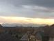 Picturesque neighborhood view showcasing well-maintained homes against a dramatic sky and mountain backdrop at 237 Dayton St, Denver, CO 80230