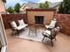 Inviting patio featuring brick accents, a cozy seating arrangement, and an outdoor fireplace for relaxation at 237 Dayton St, Denver, CO 80230