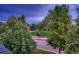 Scenic view of a neighborhood park and street, framed by lush green trees at 237 Dayton St, Denver, CO 80230