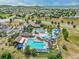 Aerial view of a community pool and clubhouse surrounded by residential homes at 2948 Open Sky Way, Castle Rock, CO 80109