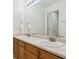 Bright bathroom features a double vanity with neutral countertops and wood cabinets at 2948 Open Sky Way, Castle Rock, CO 80109