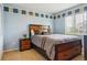 Comfortable bedroom with carpet and blue accent wall and a large window at 2948 Open Sky Way, Castle Rock, CO 80109