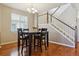 Bright dining room with modern chandelier and easy access to the staircase at 2948 Open Sky Way, Castle Rock, CO 80109
