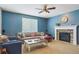 Inviting living room featuring a fireplace, plush seating, and a ceiling fan at 2948 Open Sky Way, Castle Rock, CO 80109