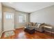 Comfortable living room features hardwood floors, a couch, and natural light at 2948 Open Sky Way, Castle Rock, CO 80109