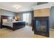 Main bedroom featuring a large bed, gray walls, and a modern fireplace at 2948 Open Sky Way, Castle Rock, CO 80109