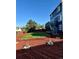 Beautiful backyard featuring a lush green lawn, wooden stairs, mulch, and stylish landscaping of rocks with plants at 21742 E Lehigh Pl, Aurora, CO 80018