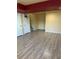 Open basement space with wood-look flooring, closet, and convenient access to the staircase at 21742 E Lehigh Pl, Aurora, CO 80018