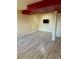 Finished basement with wood-look flooring and a mounted flat-screen TV at 21742 E Lehigh Pl, Aurora, CO 80018